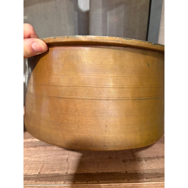 Antique copper pot with fraternity letters etched on it could’ve been used for an ice bucket