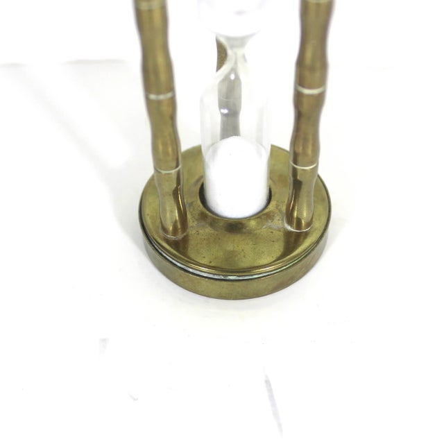 Small vintage brass and glass hourglass or egg timer. Although the sand moves, I cannot guarantee it moves at the correct...