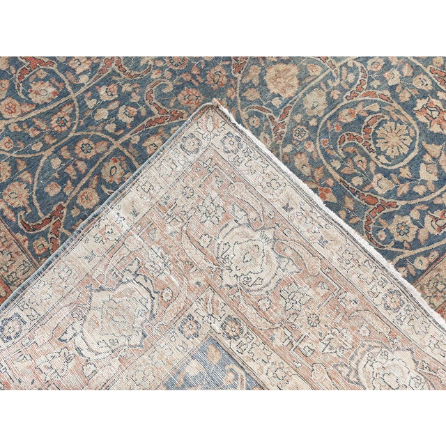 This antique Persian Tabriz rug, dating back to 1920s, features a sophisticated and elegant design that embodies the...