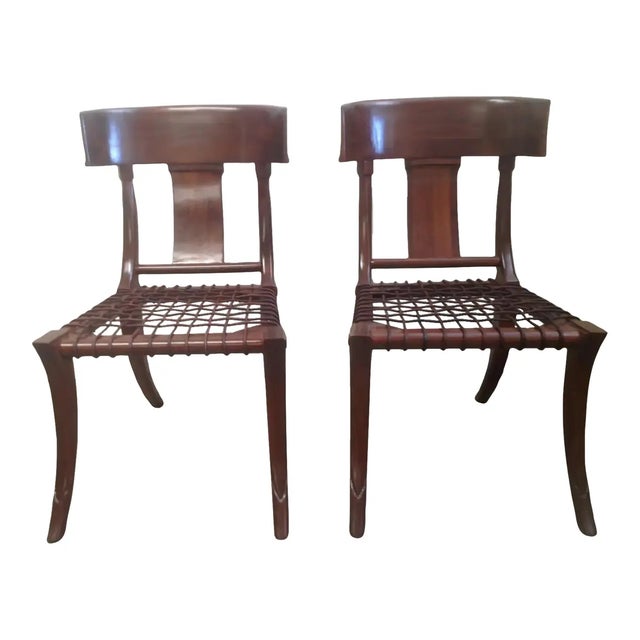 Pair of walnut Klismos chairs. Chairs are solid walnut. Finish is done in a matte natural walnut. Chairs are flawless and...