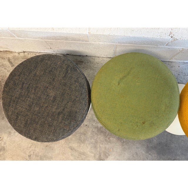 Set of 4 Saarinen Tulip Stools, all swivel 360 degrees. Original upholstery All 4 stools have the "BR 51" attribution mark...