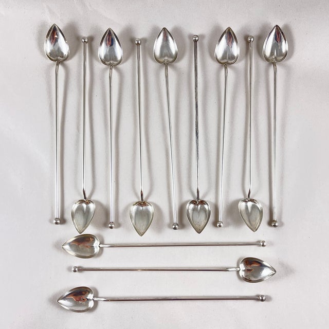 A set of twelve Sterling Silver highball or iced tea hollow sipping and stirring straws with heart or leaf shaped bowls....