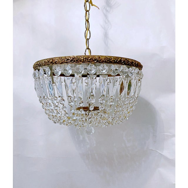 This an Italian Basket chandelier with decorative brass rim with A-chain Crystal. It has 4 candelabra based socket that...