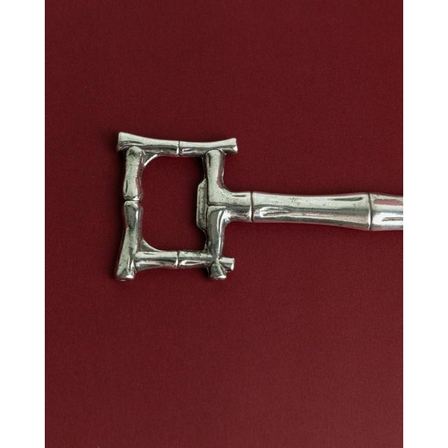 This vintage silver-plated bottle opener from the 1970s features a refined bamboo-inspired design, blending natural...
