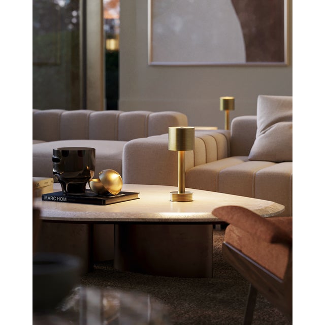 The Traverse Brass Cordless Table Lamp is a gold lamp that moves around easily. The metal lamp in a polished brass finish...