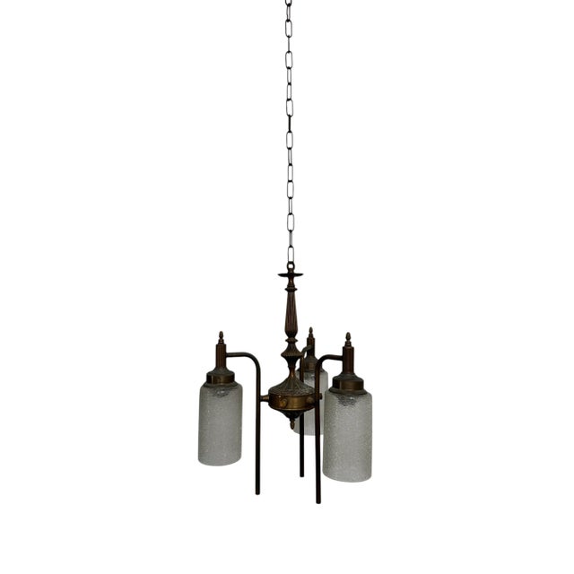 - An exquisite three-arm bronze ceiling chandelier featuring high-quality glasswork, Germany circa 1920. - The fixture...