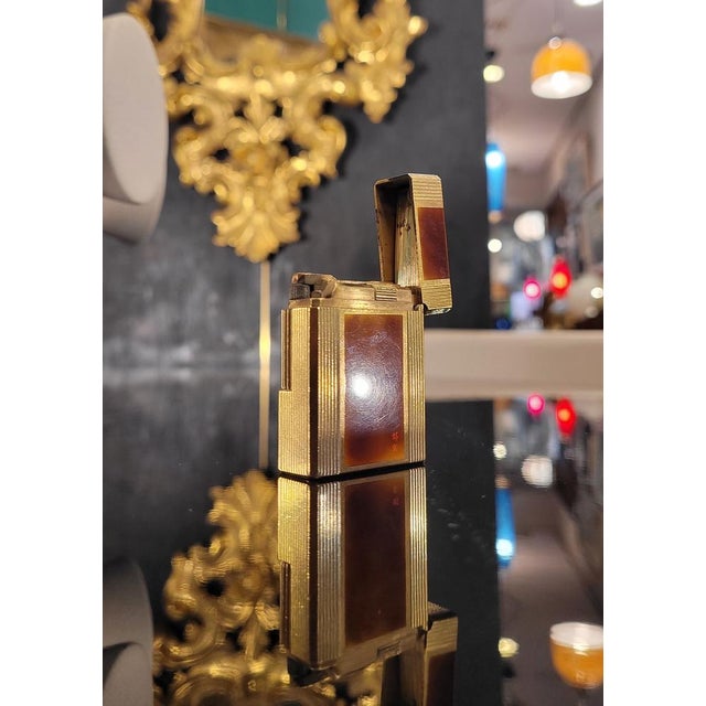Luxury lighter from the prestigious house s.t. Dupont, plated in 20 micron yellow gold and decorated in authentic chinese...
