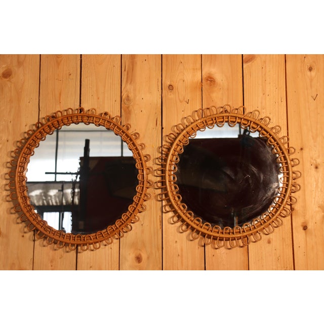 Rare pair of round rattan mirrors with a twisted design. A beautiful and iconic rattan piece by Franco Albini, Italy....
