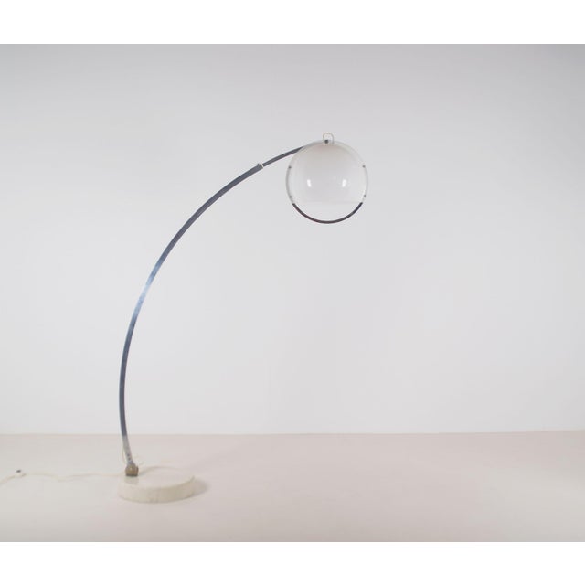 Italian vintage Arc floor lamp, an in-house design by Harvey Guzzini from 1968. This arched lamp has a heavy base made of...