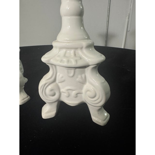 A matching pair of vintage ceramic taper candlesticks produced by Napco (Napcoware) during the mid-20th century. Molded in...