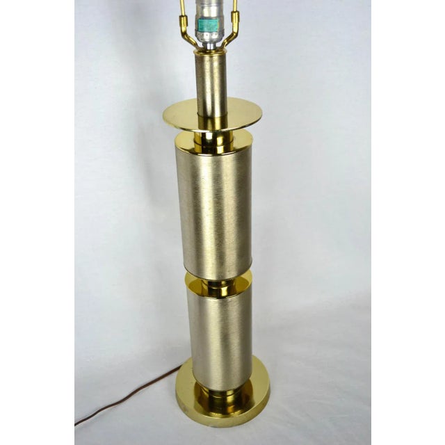 Laurel Lighting Co., 1970, sleek, modernist stacked cylinders, totem-style lamp with brushed steel body and brass accents....