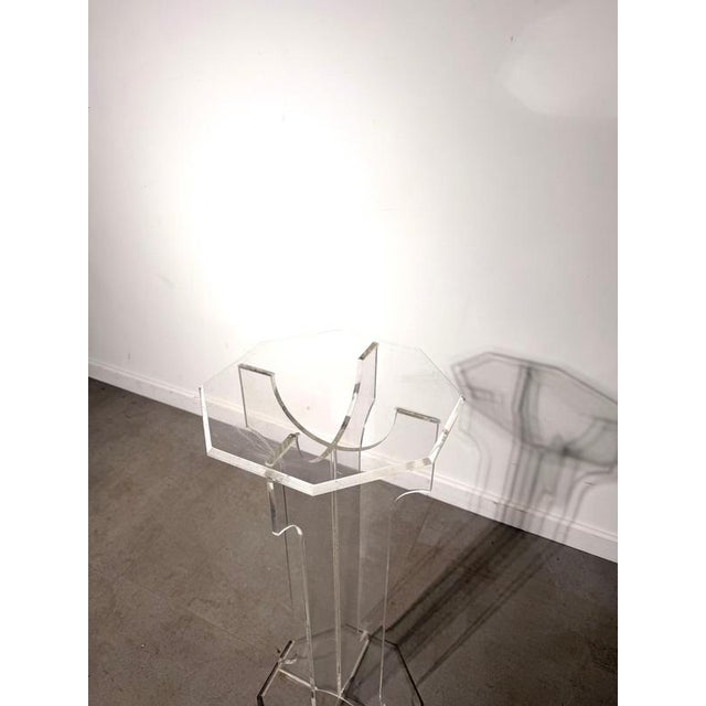 Striking vintage pedestal crafted entirely from clear acrylic glass, featuring a sculptural geometric construction with...