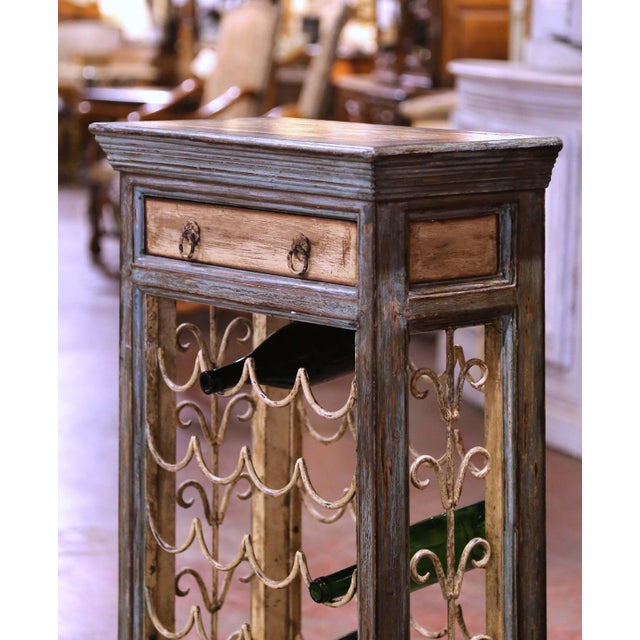 Enhance your wine cellar or wet bar with this elegant antique bottle cabinet. Crafted in France circa 1970, the painted...