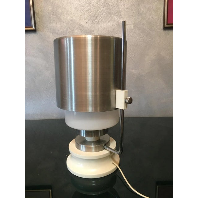 This stockroom found table lamp is made from opaline glass, aluminum, wood, and galvanized metal. European Plug (up to...