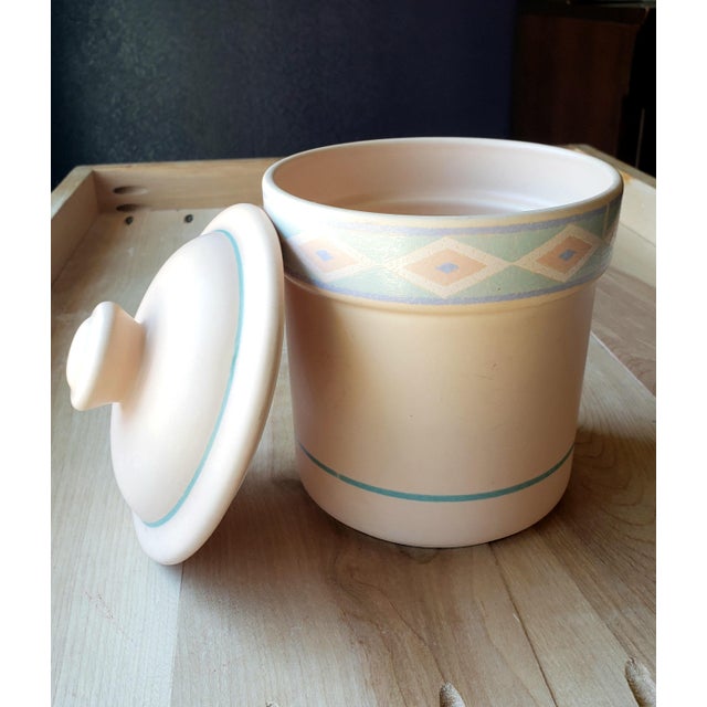 This vintage Large Canister with lid in Treasure Craft's Southwest pattern design is characterized by an earthy peach-...