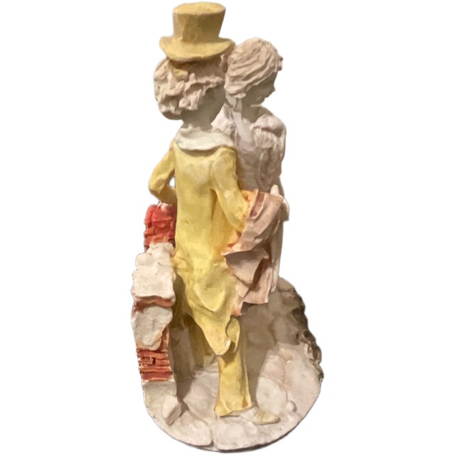 This charming vintage figurine depicts a romanticized 18th century scene of a young dandy and a lady in elegant period...