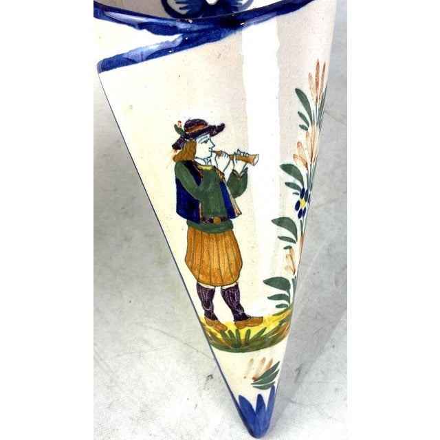 This matching pair of hand-painted French faience wall pocket vases offers a charming addition to a French Country,...