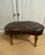 Fabulous vintage footstool; kidney shaped in thick brown pleather with wood legs. The dimensions are: 12"" high 17.5""...