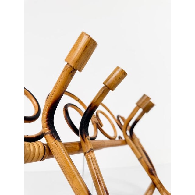 This charming Italian Mid-Century Modern wall-mounted coat rack, handcrafted in Italy circa the 1960s, beautifully...