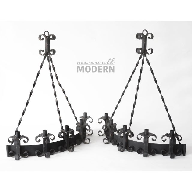 Beautiful pair of vintage mid century era gothic style wall-hanging wrought iron candelabras.