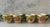 Set of 4 vintage coffee cups in the "Fresh Fruit" pattern made in the USA by Franciscan featuring a green branch handle...