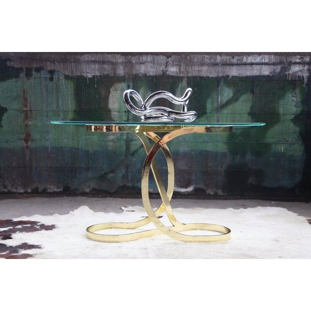 This Mid-Century Modern side / end console table features classic bent brass framework with a beautiful and very high....