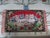 This is a Lovely Whimsical! Vintage Tapestry of a Basket of Cats that are all Dressed up on a red Background with Pink...