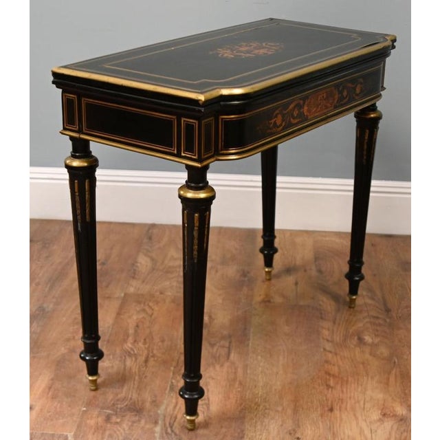 Elegant French ebonised card table in the Napoleon III taste Decorative floral marquetry to the frieze with fine gilt...