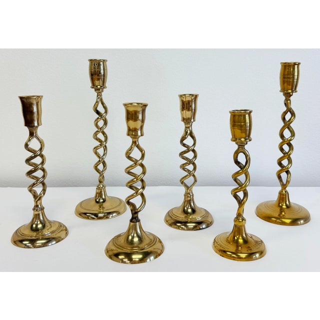 Vintage set of six (6) brass barley twist candlesticks of varying heights and design. Tallest 9.5"H, shortest 7.5"H. This...