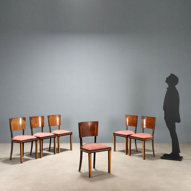 Set of 6 chairs, beech wood, natural and stained, curved plywood backrest, foam padding with fabric covering. This piece...