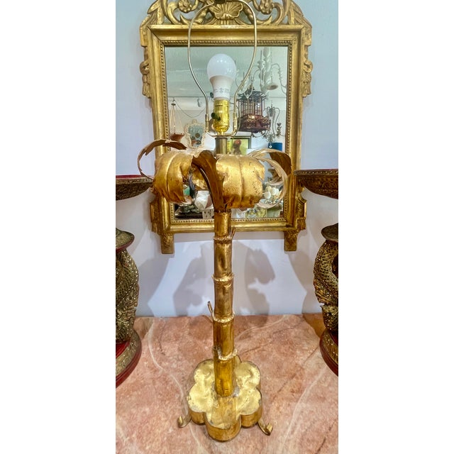 Just in this Mid Century Gilded-Metal Palm From Lamp Attributed to Maison Jansen. Having a palm tree form with a large...