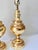 Beautiful pair of vintage lacquered brass table lamps with beaded details. The round center brightens a space with its...