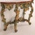 The green painted and gilt carved frame boasts a faux marble decorated top above a ornately carved frame with overall...