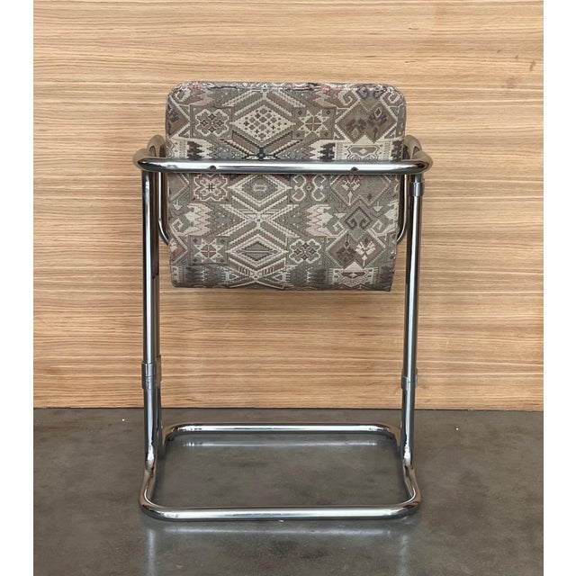 Set of ten vintage modern dining chairs with flat bar polished chrome frames. Seats are suspended in a cantilever spring...