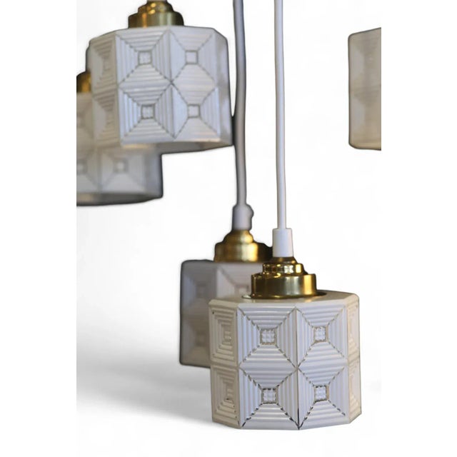 Hanging window lamp with an octagonal shape where the dome is in white and clear glass. The knob on the lamp is in brass....