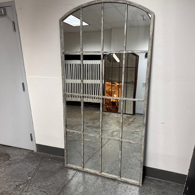 Design Plus Gallery presents the Amiel Ivory Arched Mirror by Uttermost. This oversized mirror showcases an architectural...