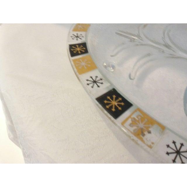 Cool mid-century oval footed tempered glass serving platter for meat or poultry. Platter features an atomic design rim in...