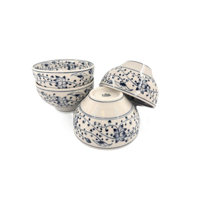 A beautiful set of four Bat Trang ceramic bowls featuring an intricate blue-and-white floral design. Each bowl is...