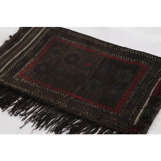 Hand-knotted in wool, this 2x4 vintage Pakistani rug from circa 1950- 1960 reflects a rich tribal heritage through its...