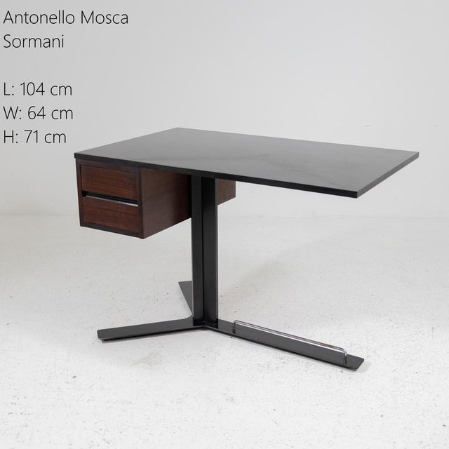 Desk designed by Antonello Mosca. Frame in painted metal with chrome accents. Black Formica top, drawer unit in iroko...