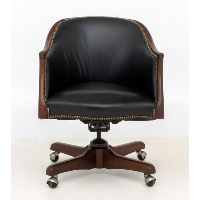 Modern Black Leather Upholstered Mahogany Swivel Office Chair, brass nail head trim, wood legs on casters. 33" H x 24.75"...