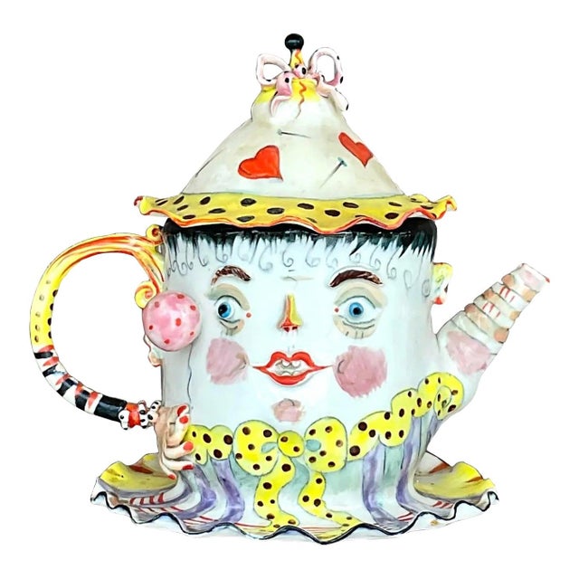 A stunning and unique vintage teapot with an arrangement of colors painted on its ceramic surface. Acquired at a Palm...