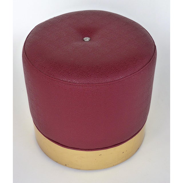Offered for sale is a low stool upholstered in red faux-shagreen vinyl with a bright gold finished wood base. The top has...