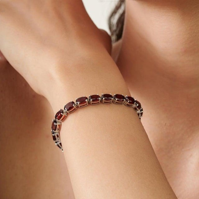 A classic garnet bezel set link bracelet in 925 sterling silver, defined by its clean lines and enduring appeal. The...