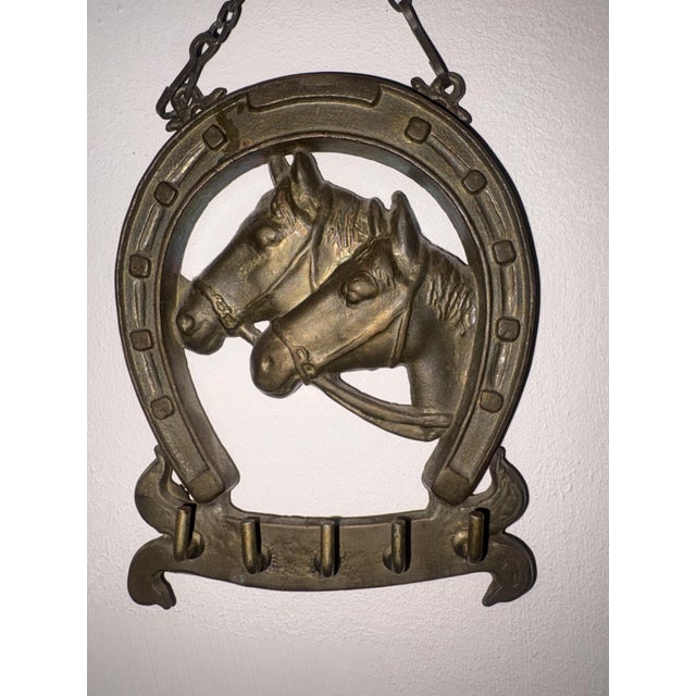 Antique brass horseshoe shaped wall key holder with two embossed horse heads, full height with chain 19cm, height 14cm,...