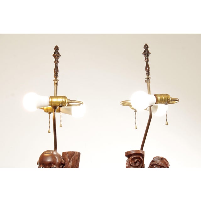 High Quality Vintage Pair Of Carved Wood Figural Table Lamps Featuring Detailed Sculptural Figures Mounted On Circular...