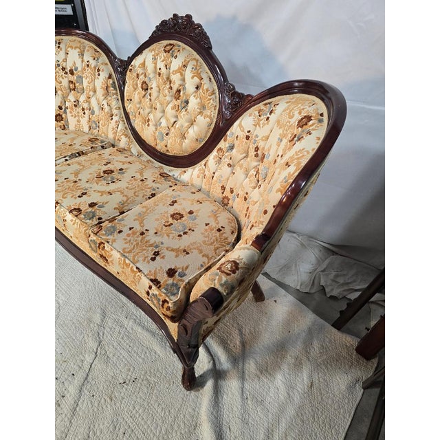 Vintage Victorian-style settee by Kimball featuring an ornately carved hardwood frame with a distinctive triple medallion...