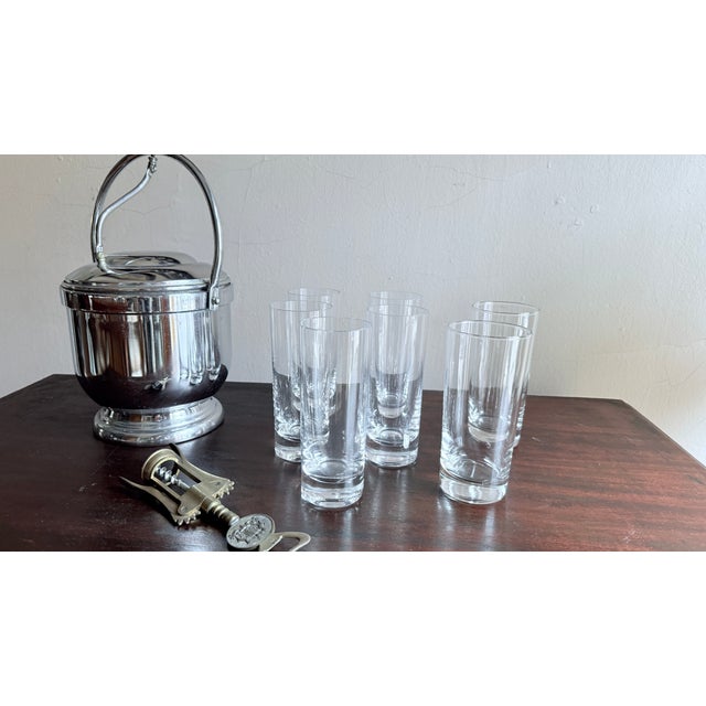 Set of four highball glasses in the style of the Château collection, featuring a tall, cylindrical form with a thick base....