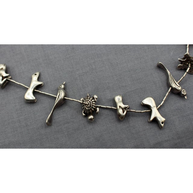 Mid-20th century Zuni or Navajo Sterling Silver Fetish Necklace. Each handmade of liquid silver: birds, frogs, bears &...