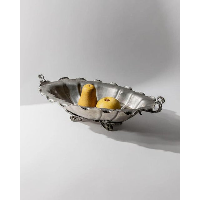 This large vintage pewter centerpiece bowl from the 1940s is a striking example of classic table décor with expressive...
